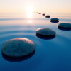 Stones in calm water with evening sun