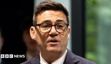 Andy Burnham at the launch of No 10 North wearing a dark suit, white shirt and his black-rimmed glasses