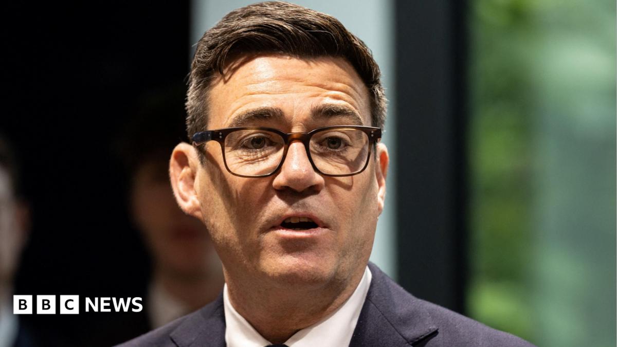 Andy Burnham at the launch of No 10 North wearing a dark suit, white shirt and his black-rimmed glasses