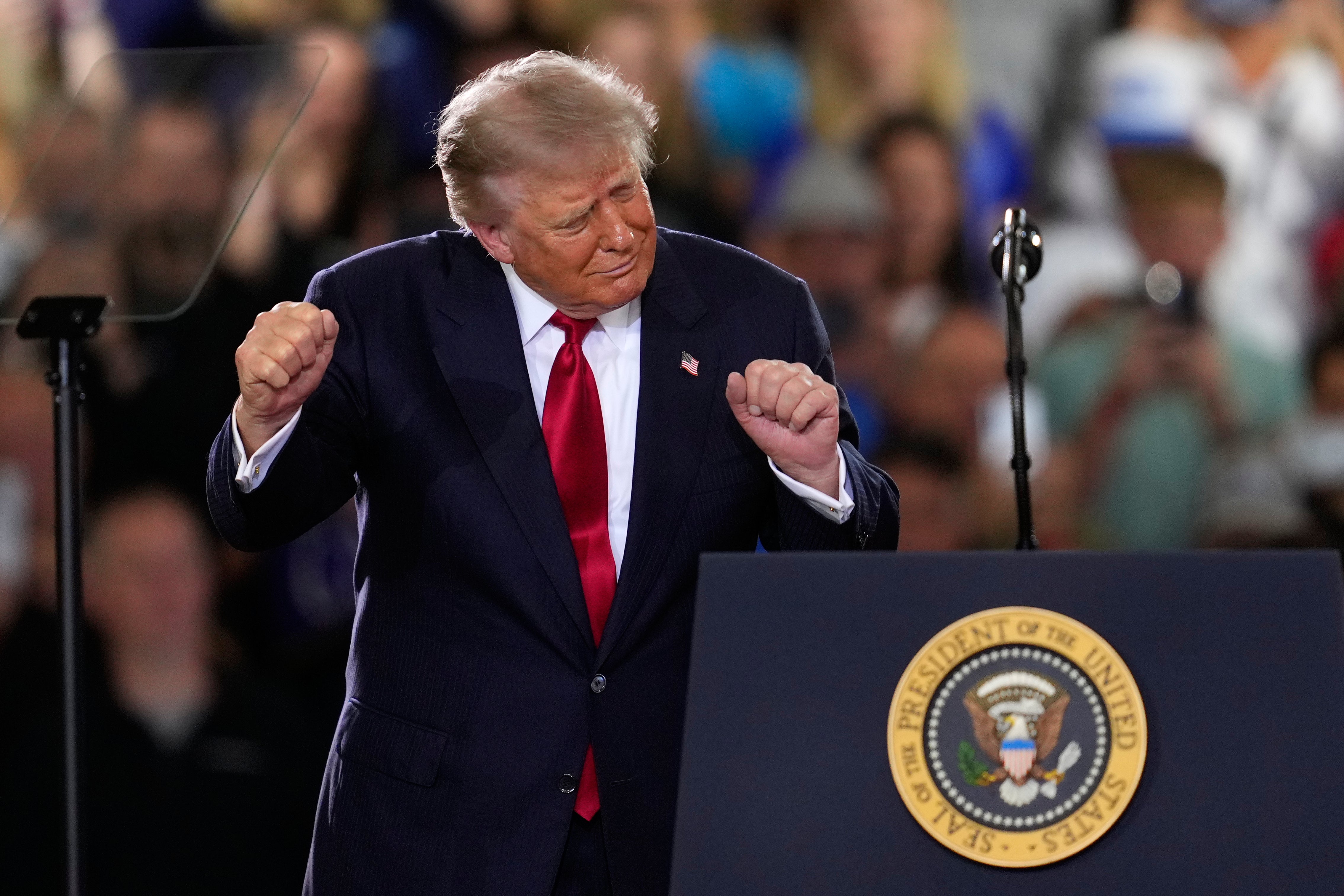 President Donald Trump dances after speaking at an event at the General Motors Proving Ground Monday,