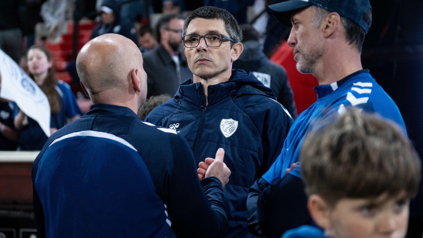 Toulouse Ollympique head coach Sylvain Houles pictured in discussions with members of his staff ahead of a game in 2026
