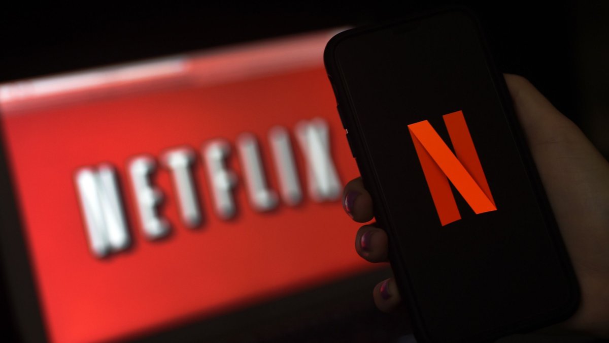 (FILES) In this file photo illustration a computer screen and mobile phone display the Netflix logo on March 31, 2020 in Arlington, Virginia. - Bridgerton has become Netflix's most popular new series, with more than 82 million households tuning in to watch the period drama, the streaming service has announced. (Photo by Olivier DOULIERY / AFP) (Photo by OLIVIER DOULIERY/AFP via Getty Images)