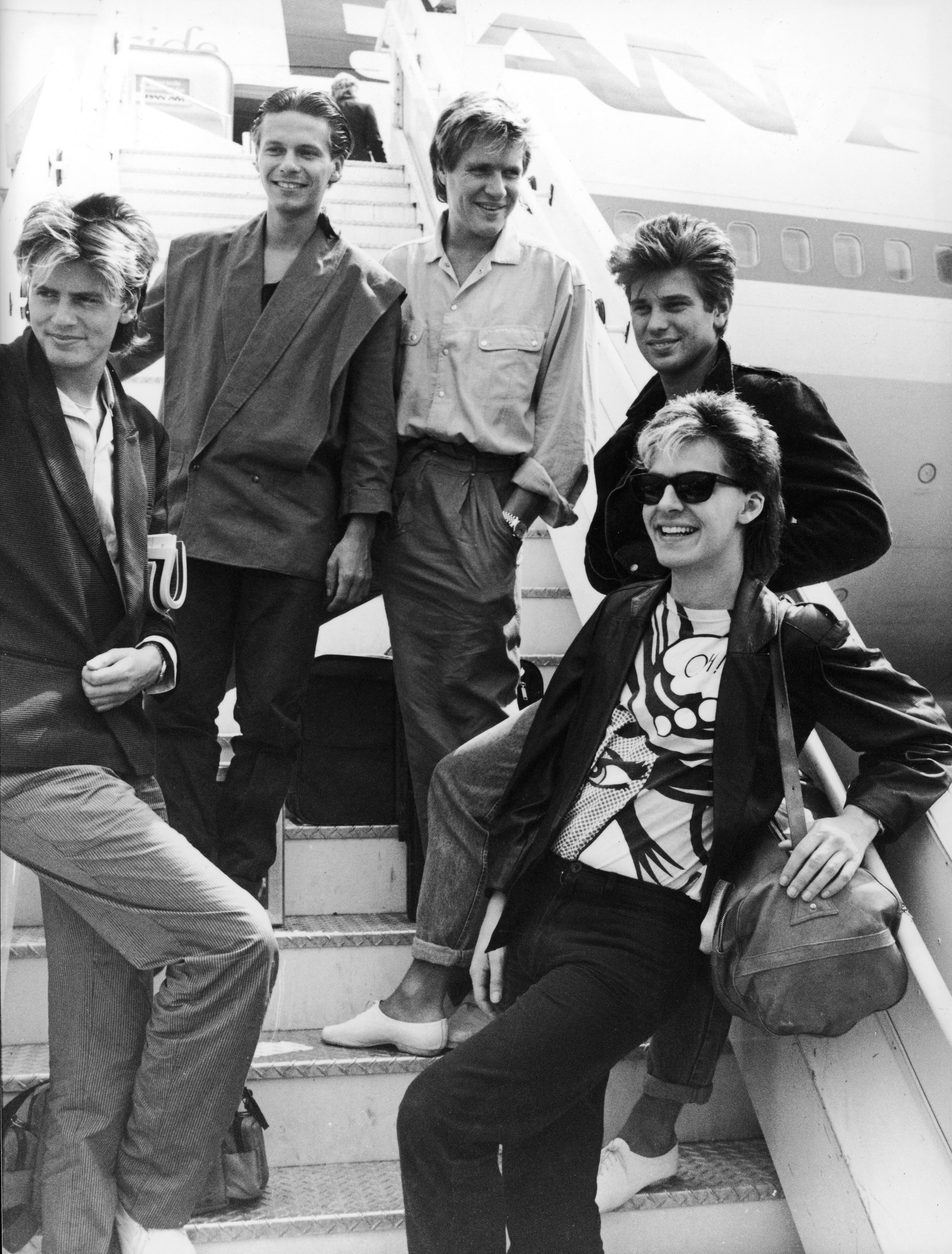 Duran Duran pose at Heathrow Airport before departing for Australia, July 1983. L-R: Bassists John and Andy Taylor (unrelated), singer Simon Le Bon, drummer Roger Taylor and keyboardist Nick Rhodes