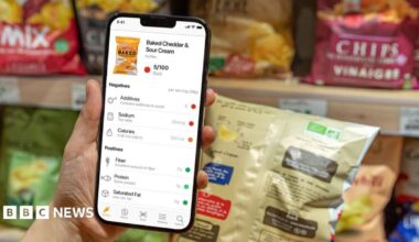 Nathalie uses her phone to scan a product.