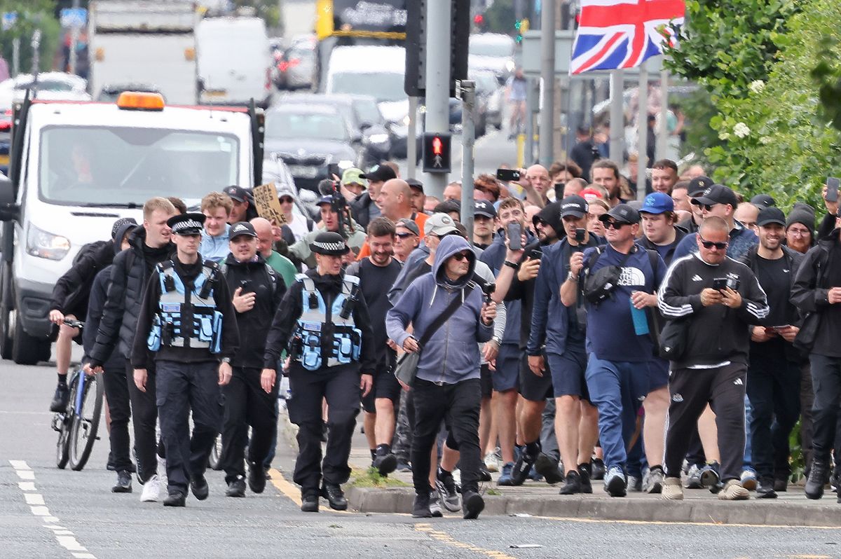 Anti-immigration protestors who gathered in Walton march to city centre