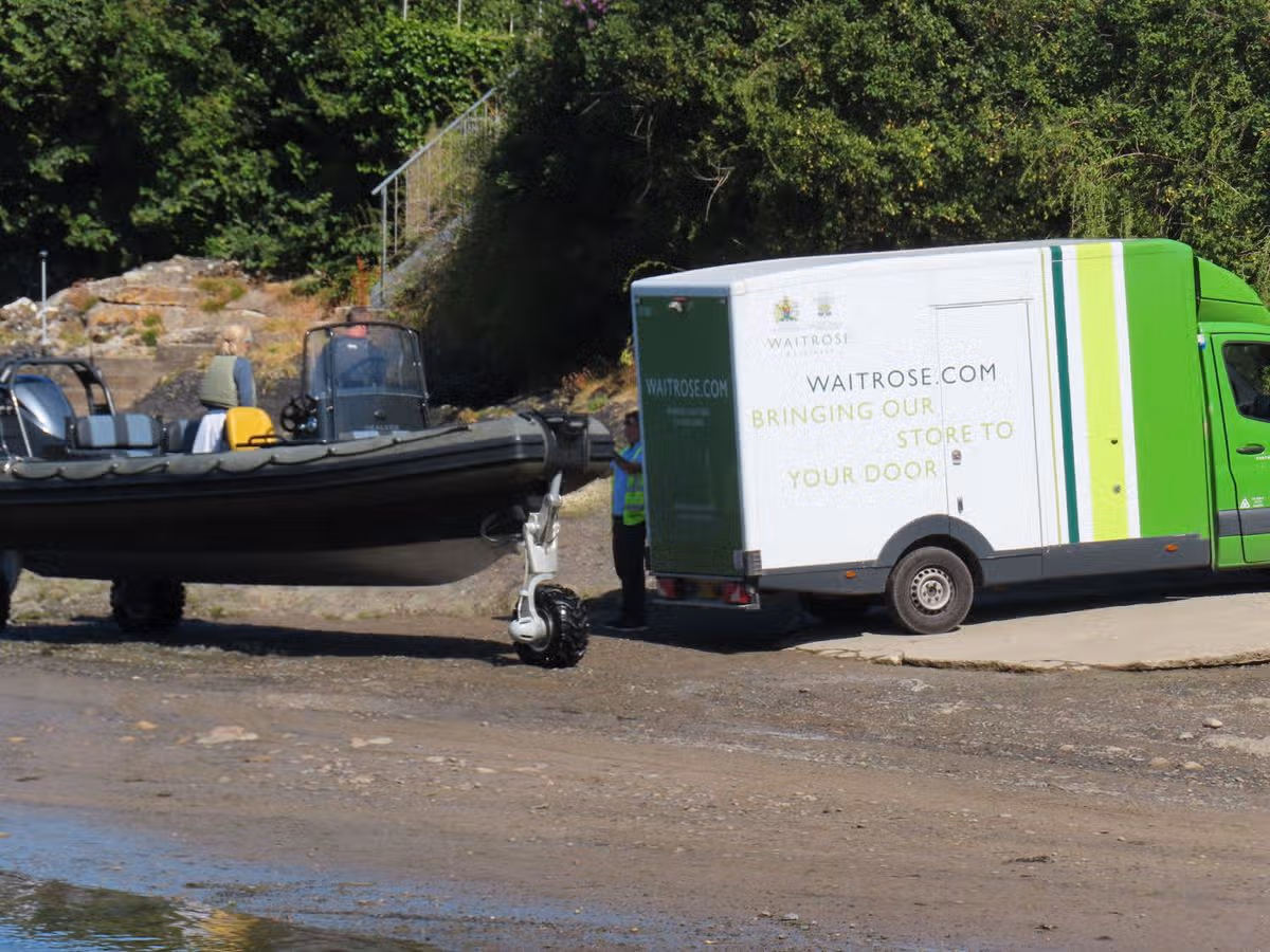Bear recently seen picking up his shopping by boat on the shoreline