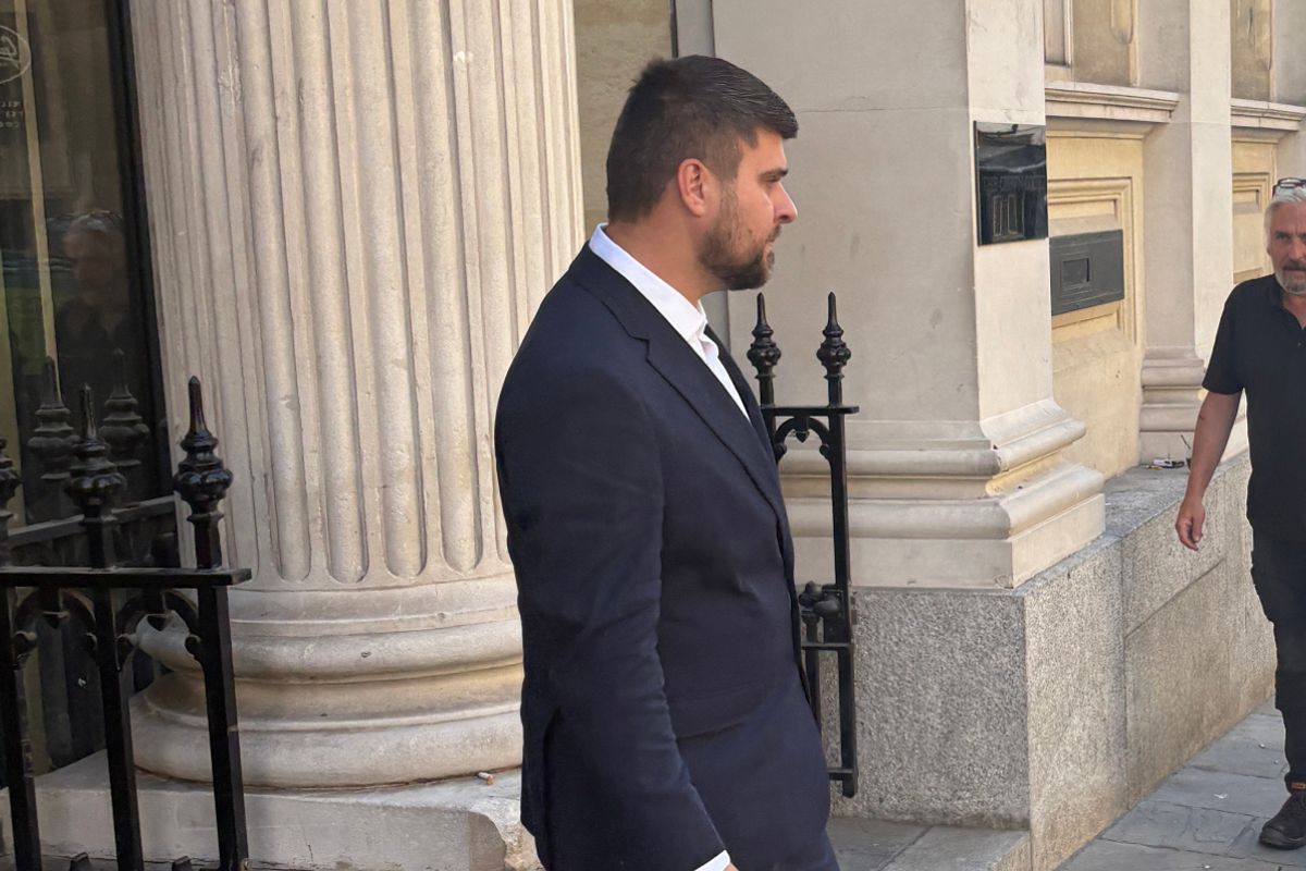 White man wearing suit leaving court
