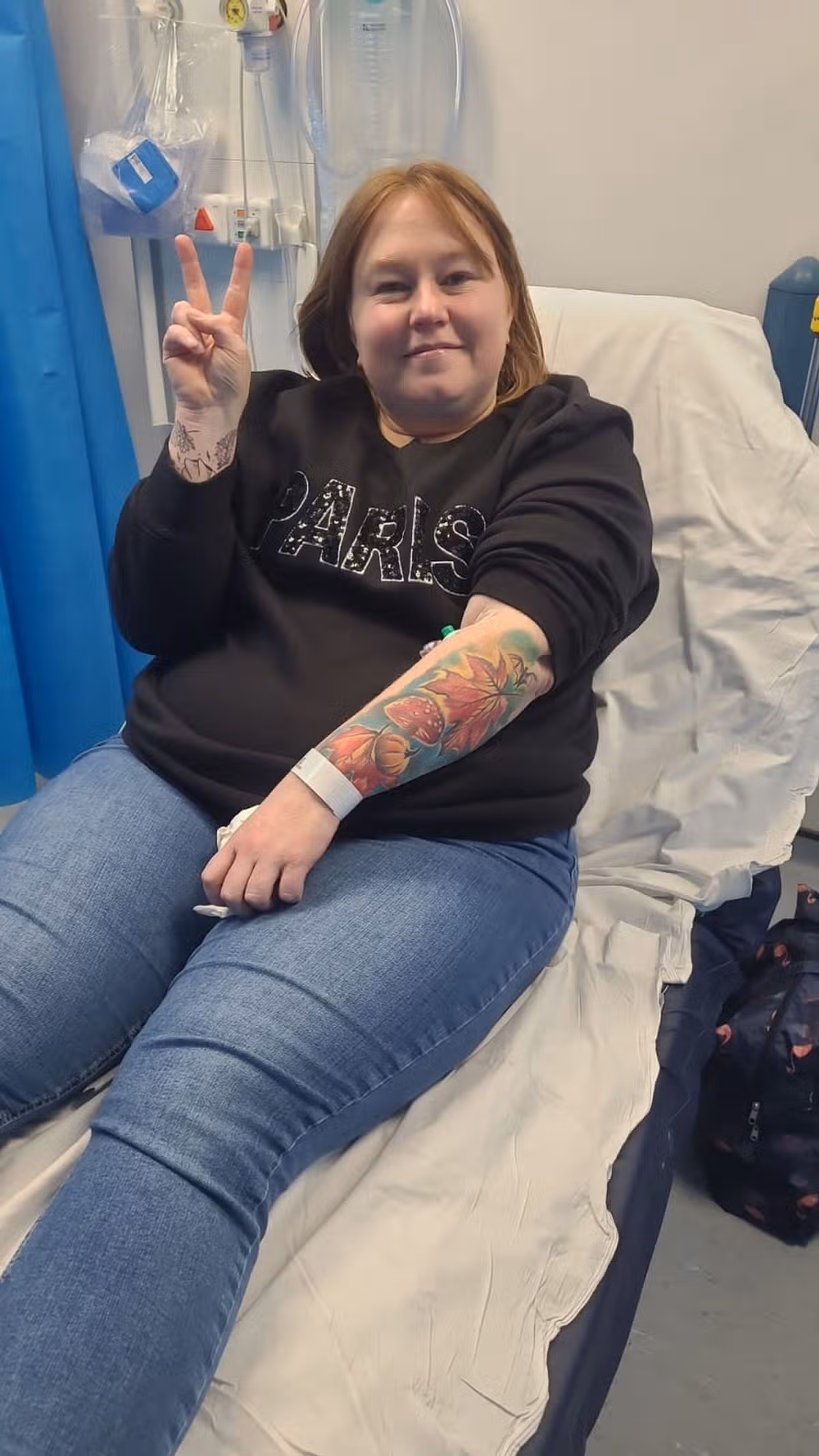 Chantelle giving a victory sign from hospital bed