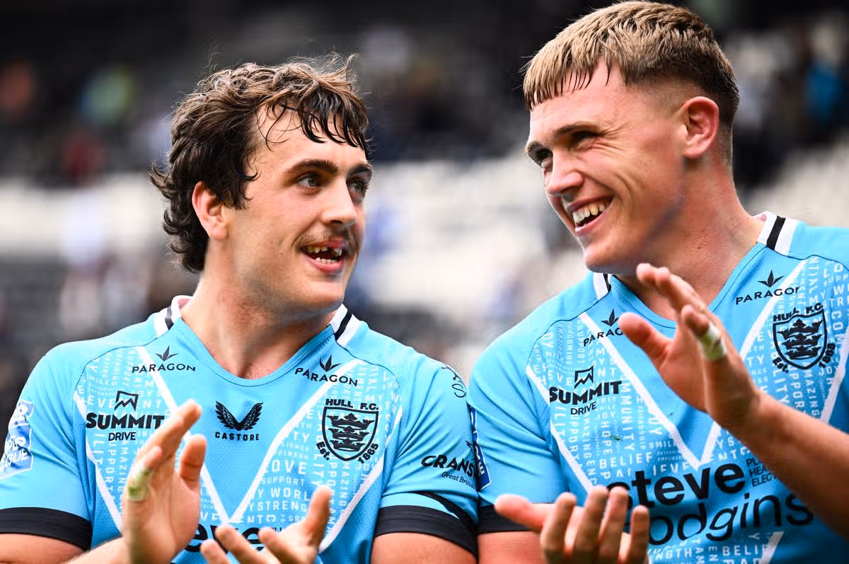 Hull FC forwards Max Wood and Harvie Hill celebrate victory over Huddersfield.