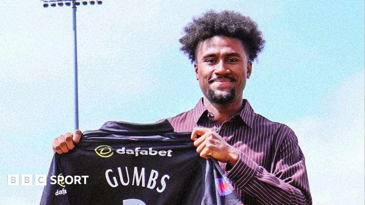 Sheridon Gumbs holds up a Leicestershire shirt after signing for the County Championship side