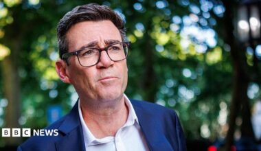 Labour MP Andy Burnham photographed outside against a blurred background of trees near the river Thames in central London.