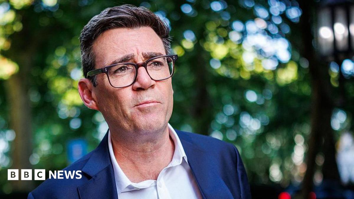 Labour MP Andy Burnham photographed outside against a blurred background of trees near the river Thames in central London.