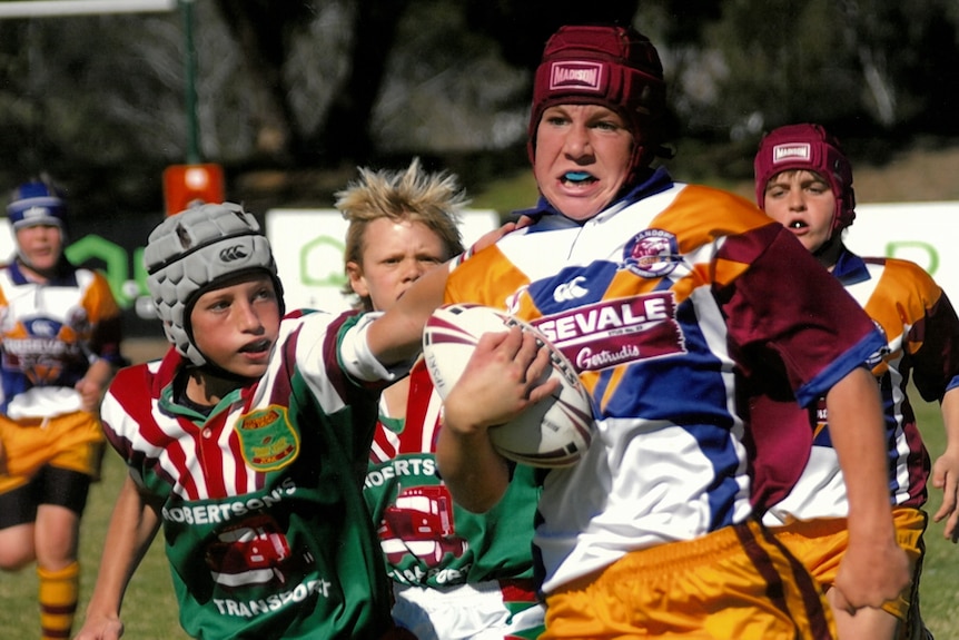 Boys in headgear play football.