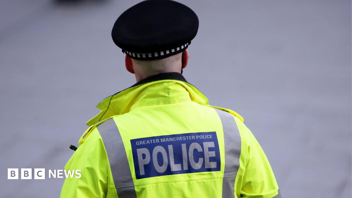 Back of a hi-vis jacket reading 'Greater Manchester Police'.