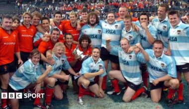 Wales players, some in red Wales shirts and some in blue and white Argentina jerseys, pose together on the pitch on the 2004 tour of Argentina.