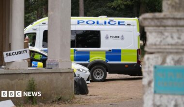 A police van and a police car parked next to each other.