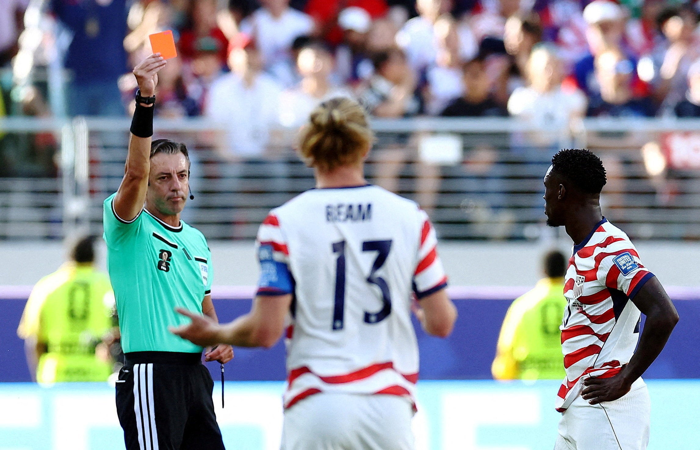 Folarin Balogun of the U.S. is shown a red card by referee Raphael Claus
