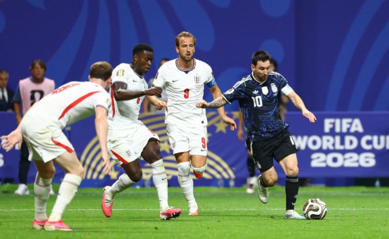 Argentina's Lionel Messi in action with England's Marc Guehi and Harry Kane