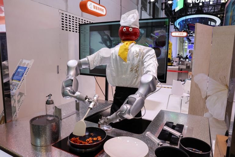 A humanoid robot that cooks is displayed at the Xi Xiang booth during the World Artificial Intelligence Conference (WAIC) in Shanghai, China, July 17, 2026