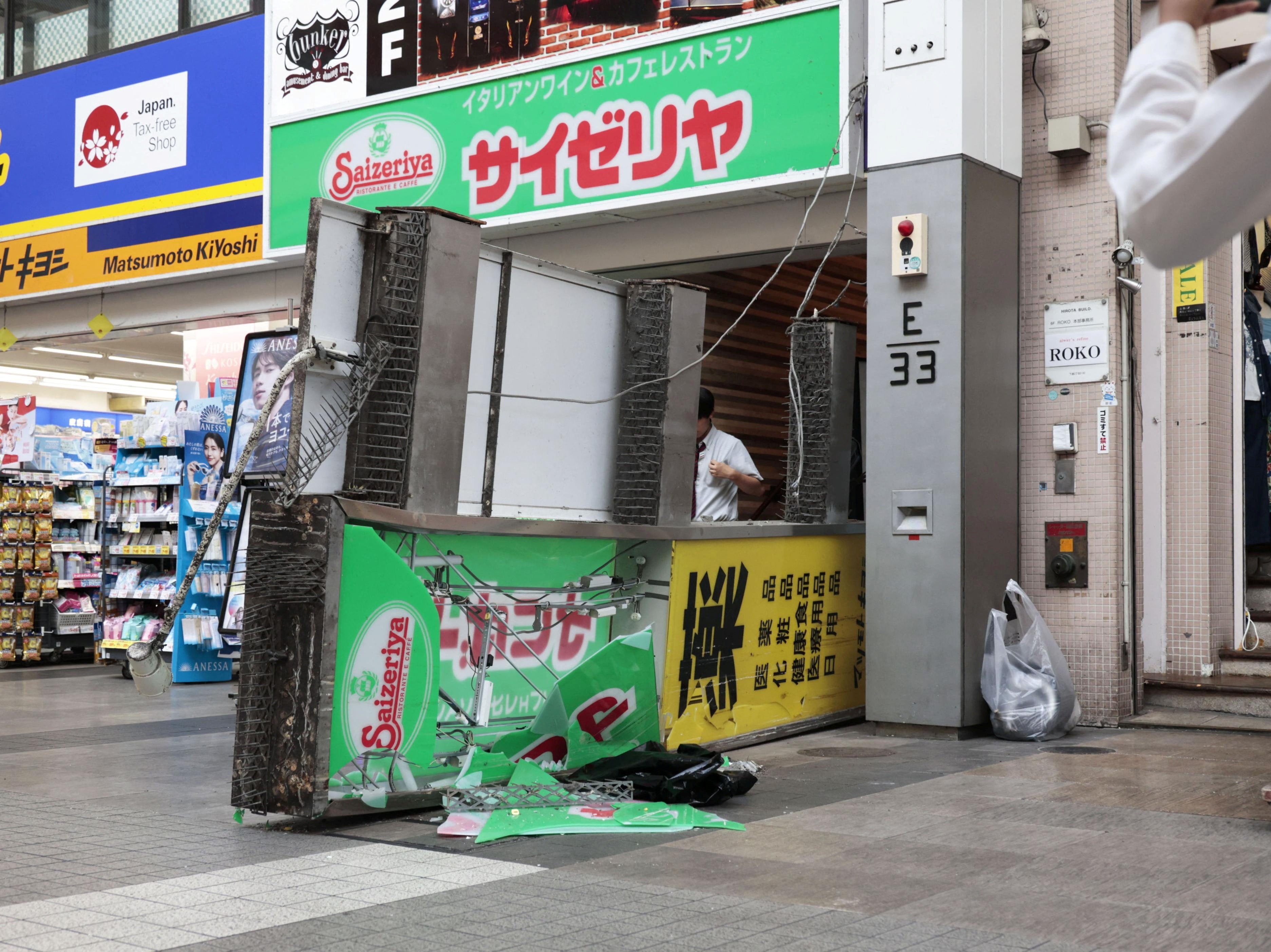 A damaged fallen signboard outside a Saizeriya restaurant