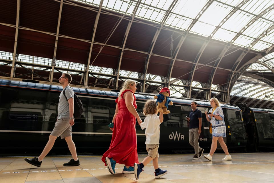 <p>Passengers make their way through Paddington train station in central London</p>