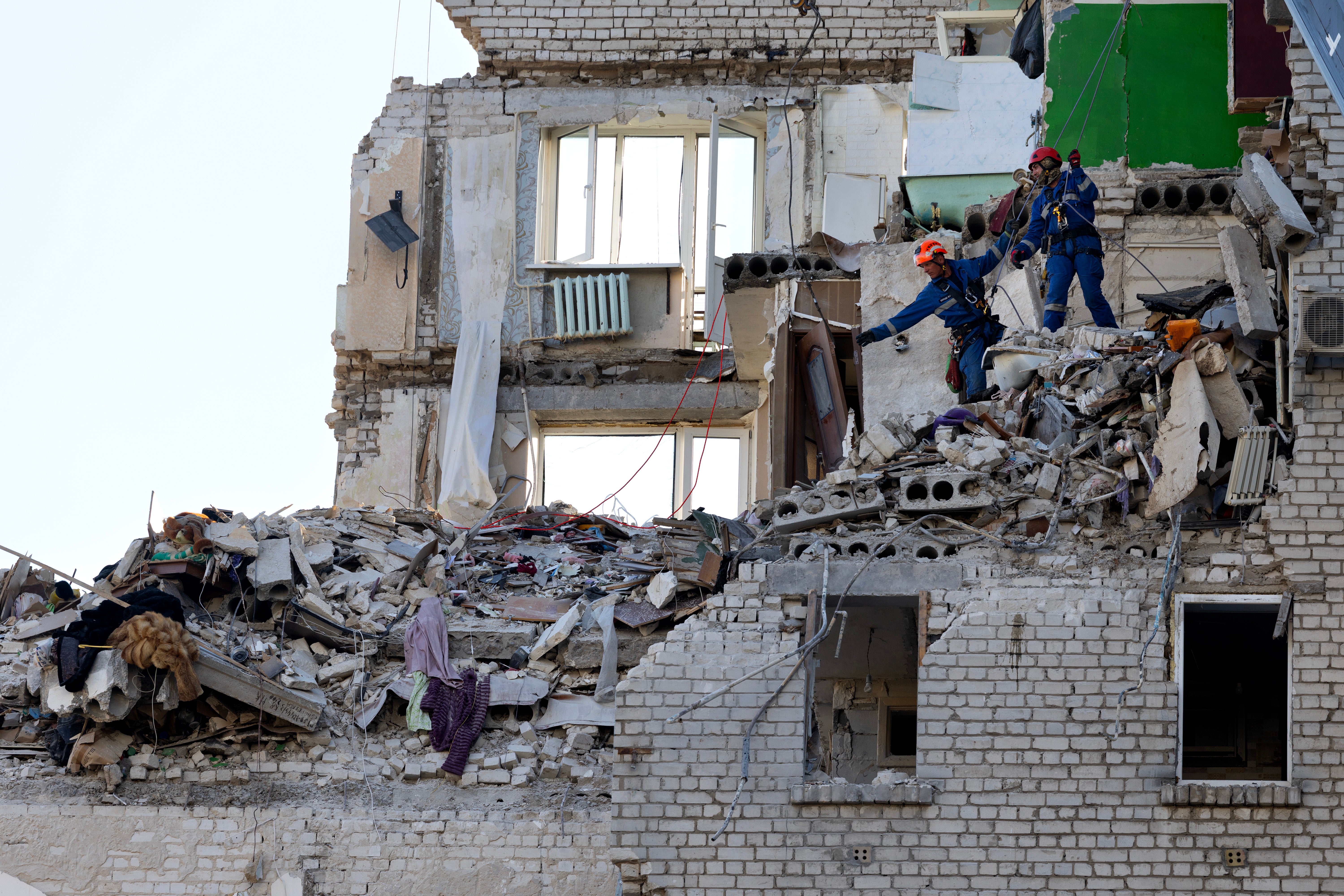 Rescue workers continue to search for survivors after a missile attack in Kyiv