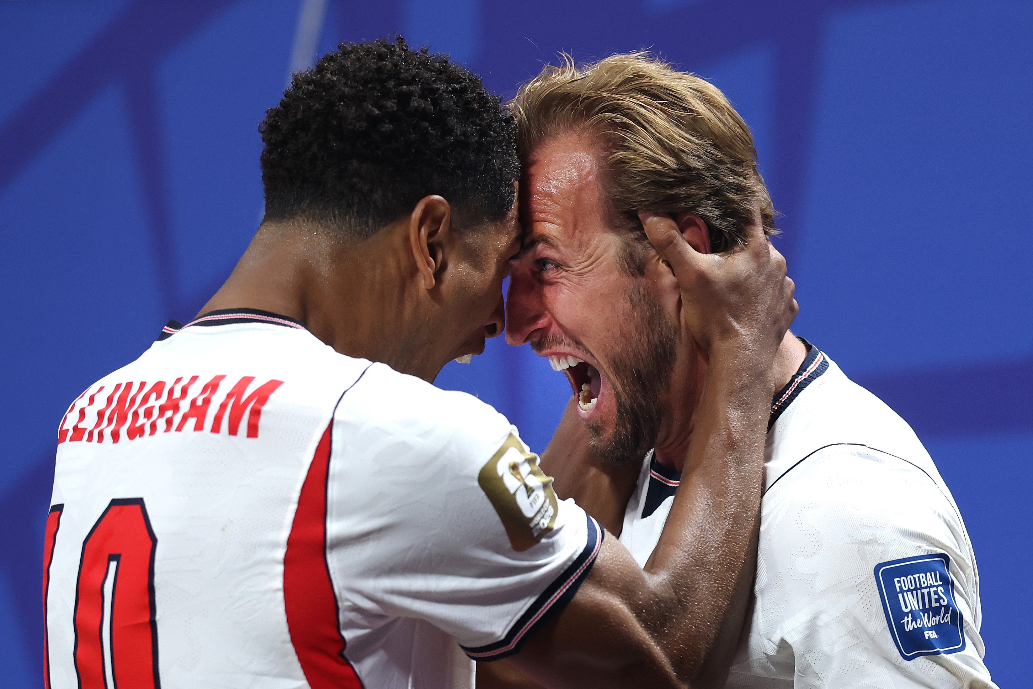 Harry Kane of England celebrates with teammate Jude Bellingham after scoring his team's first goal