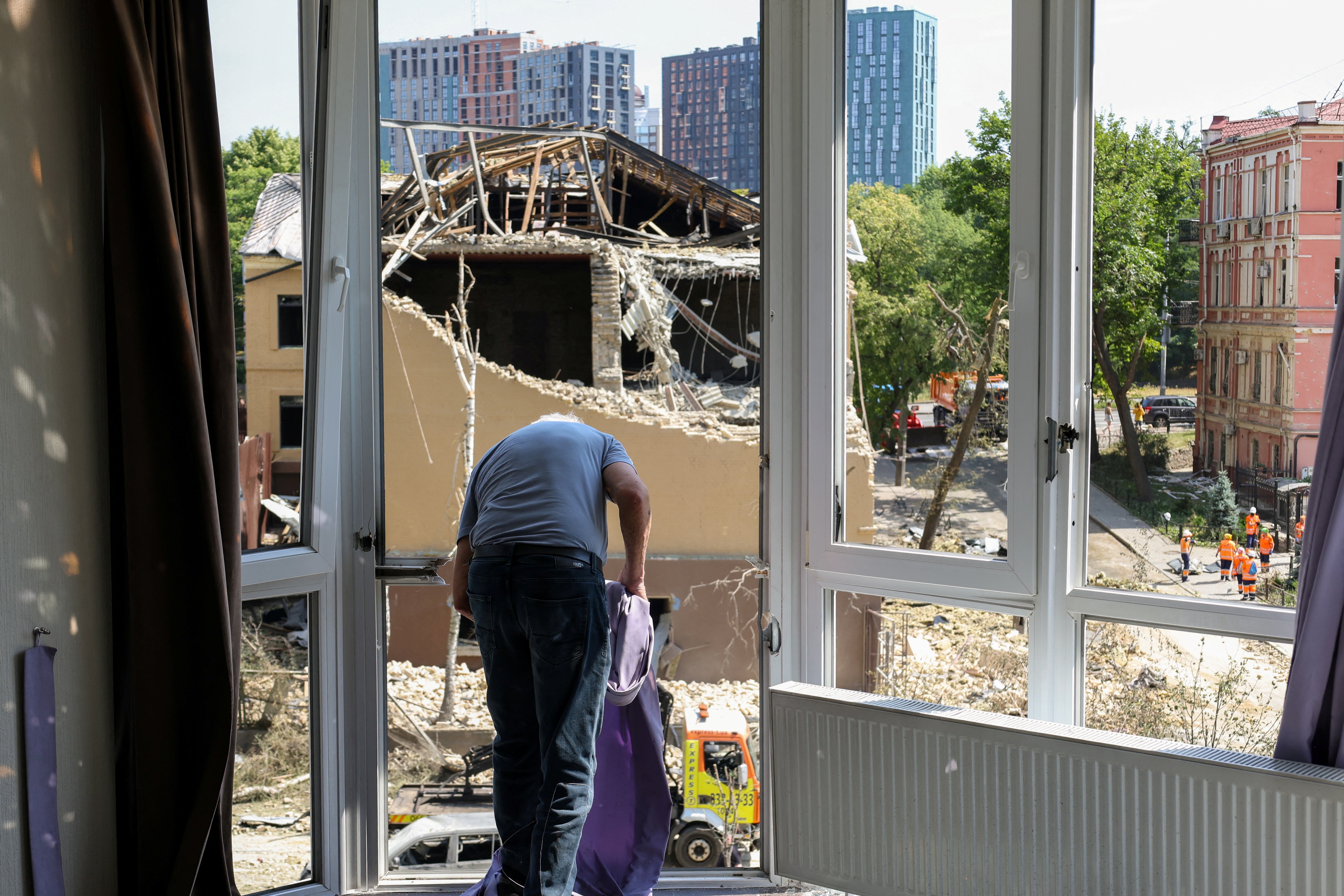 A local resident cleans his damaged apartment