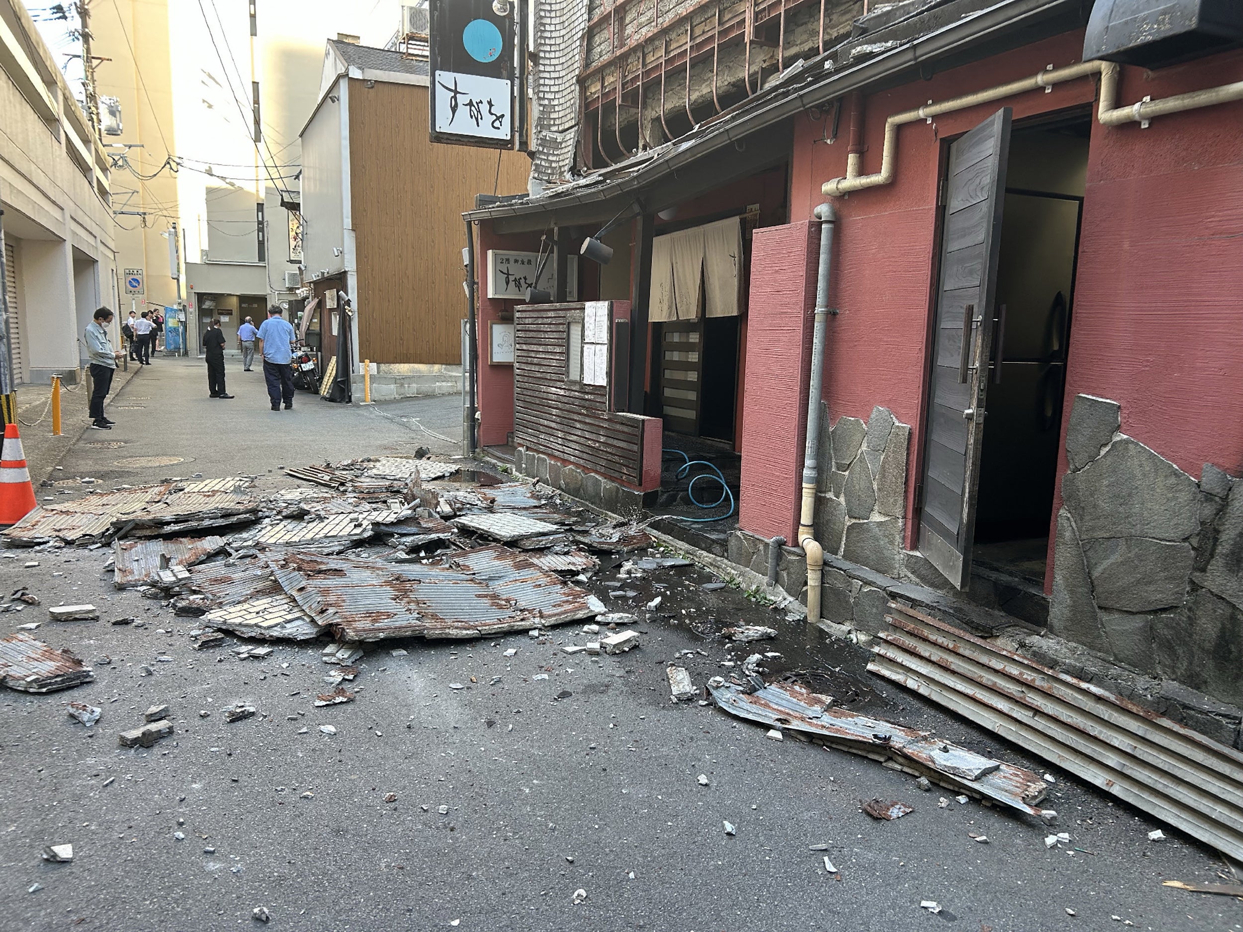 The exterior wall of a shop is seen collapsed in an earthquake, in Kumamoto City
