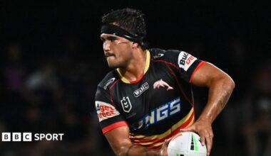 Mason Teague, with black strapping around his forehead, playing for Dolphins in the NRL