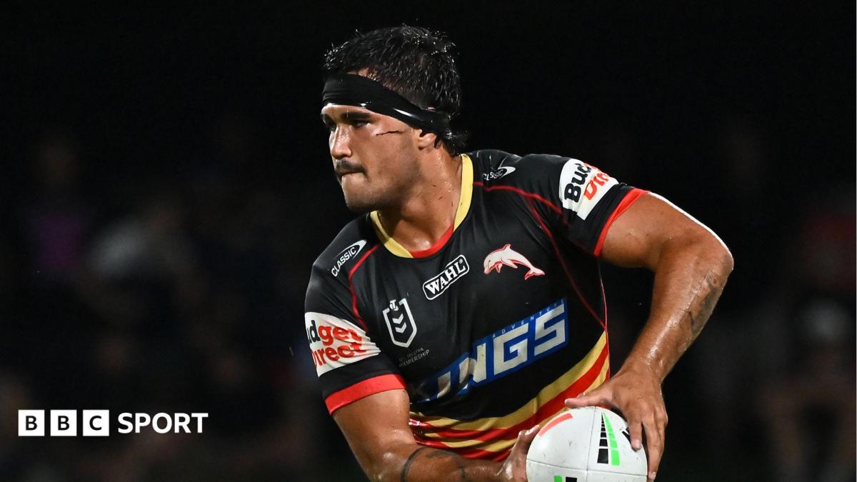 Mason Teague, with black strapping around his forehead, playing for Dolphins in the NRL