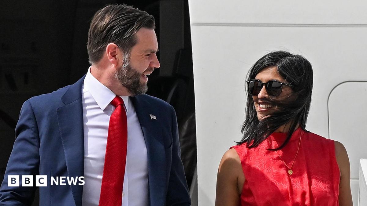 JD Vance and his wife Usha Vance disembark from an aircraft and smile at each other