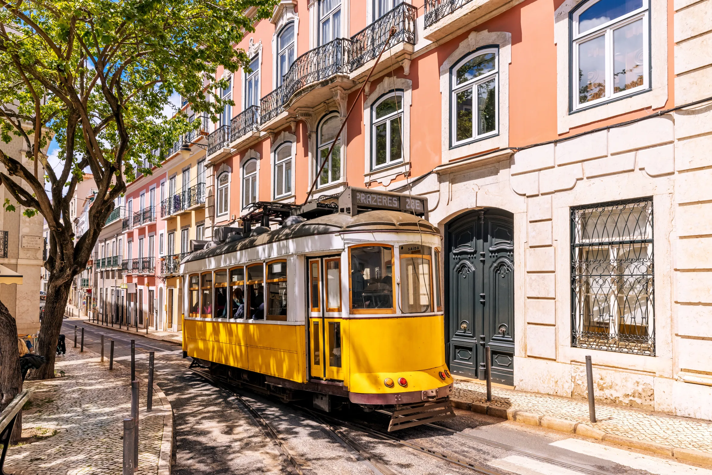Yellow tram on the streets of Lisbon on a sunny day, Portugal