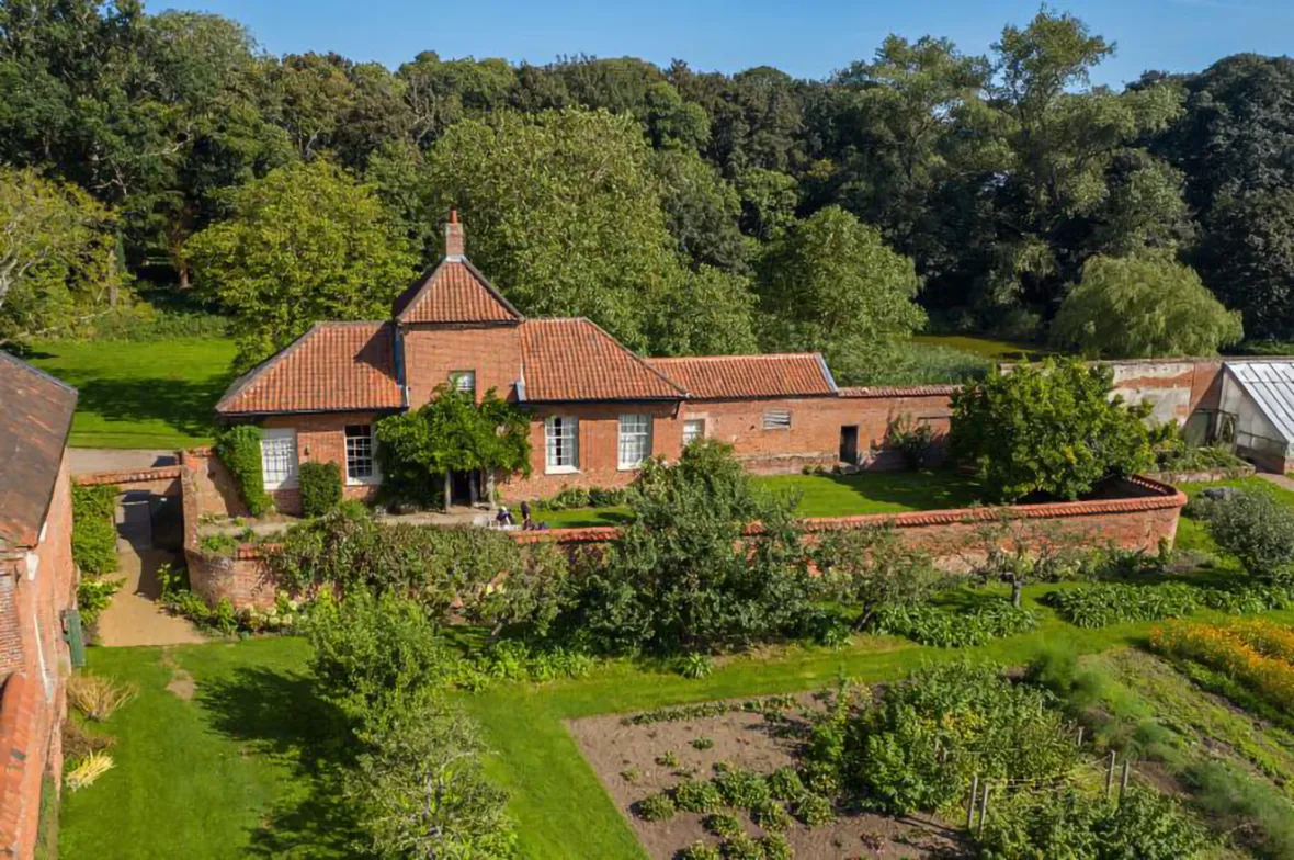 The Garden House at Wolterton, a brick house with an enclosed garden and surrounding woodlands.