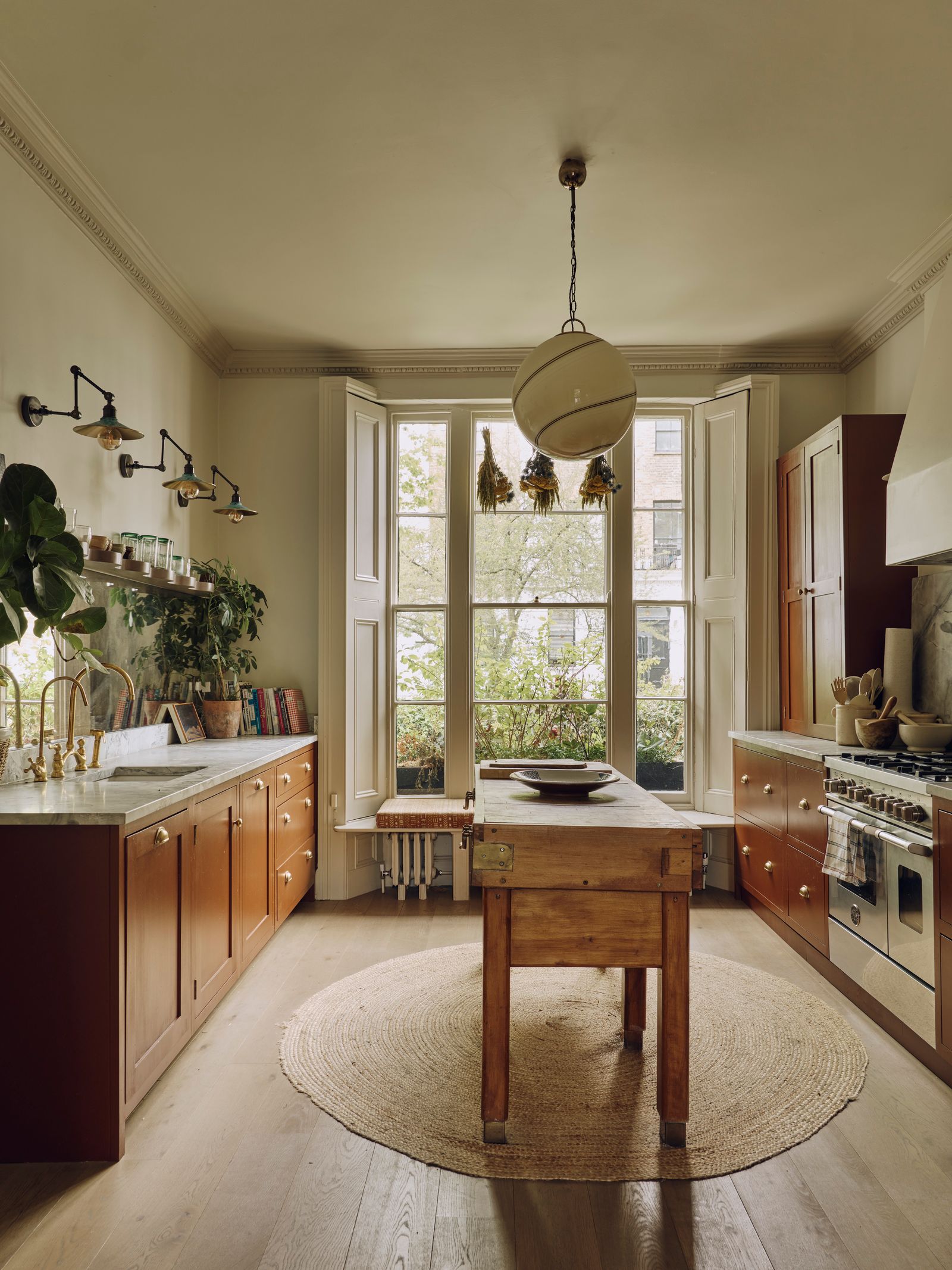Image may contain Home Decor Window Rug Bay Window Indoors Kitchen Cooktop Interior Design Plate and Plant