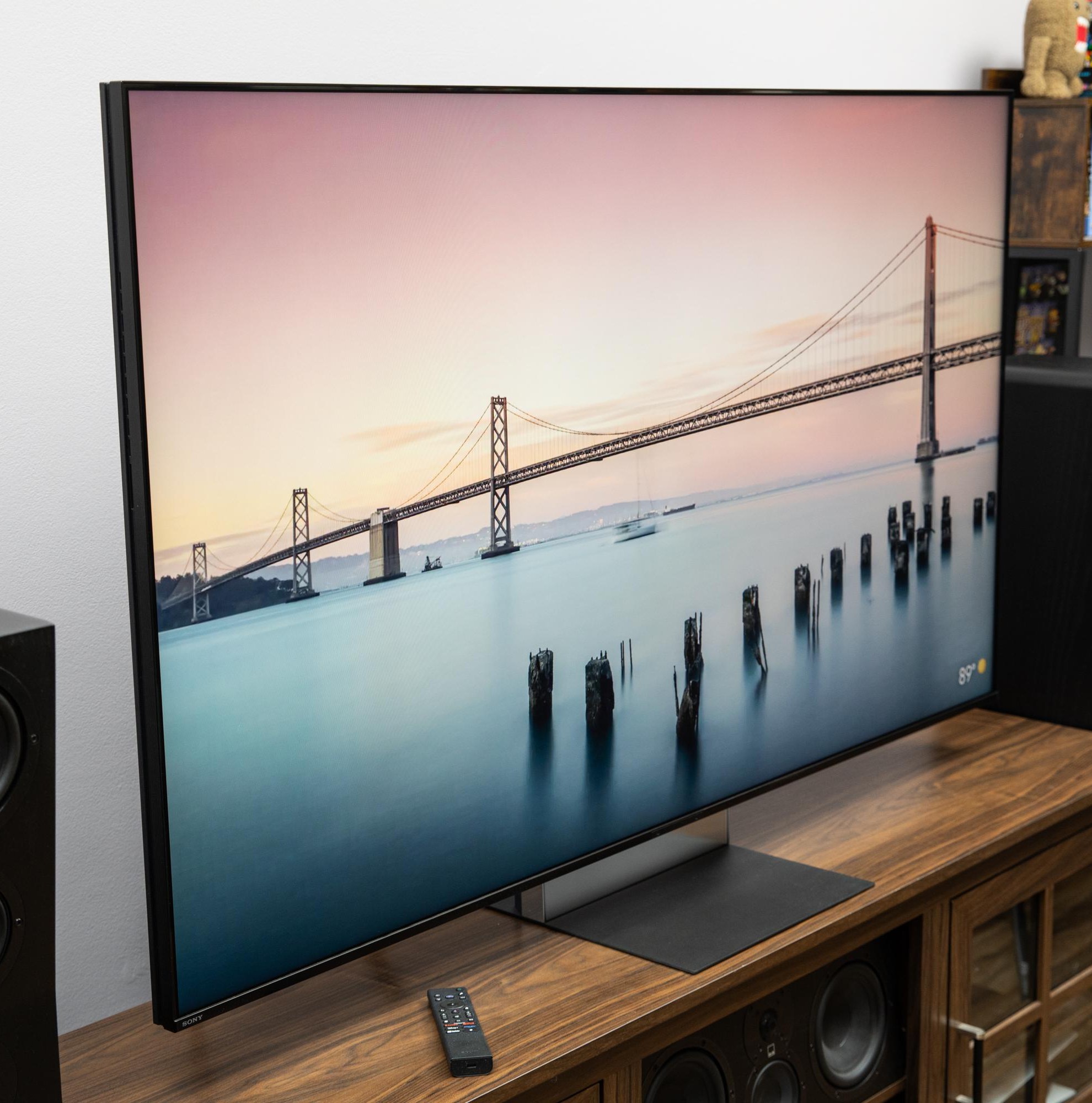 The Sony Bravia 9 II RGB LED TV on a wooden credenza with SVS speakers on either side.