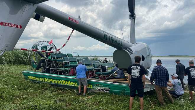 A helicopter on an airboat. a helicopter that landed on an airboat.