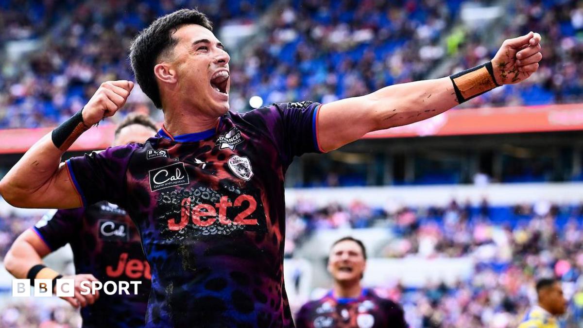David Armstrong celebrates scoring a try for Leigh Leopards by holding his left arm out and his right hand towards his head in the style of an archer.