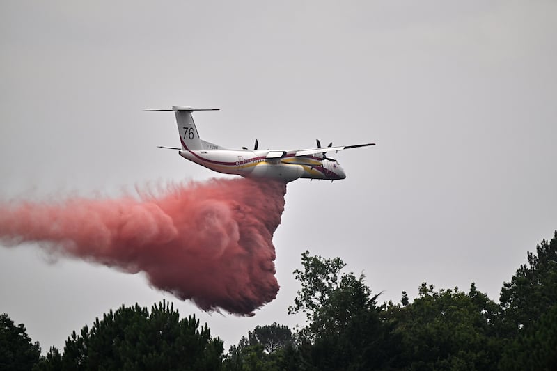 A De Havilland Canada DHC-8-400 Dash 8 operated by the French civil defence agency drops fire retardant as wildfires rage near Marcheprime, outside Bordeaux. Photograph: Emma Da Silva/AP