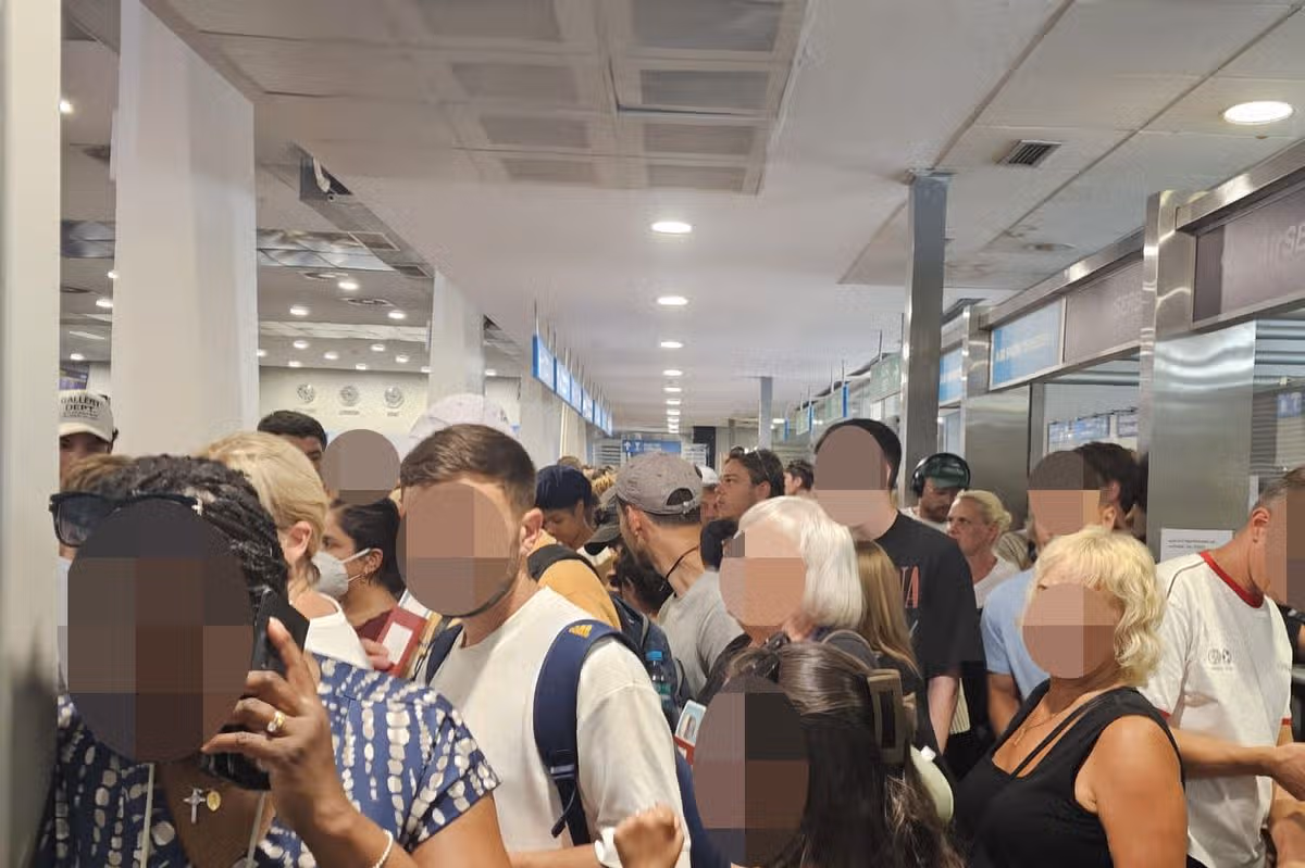 Passengers in crowded corridor in airport