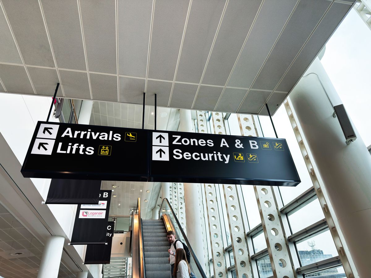 Manchester, UK - October 04, 2025: Bright interior signage directing arrivals lifts zones A and B and security at Manchester Airport, UK.