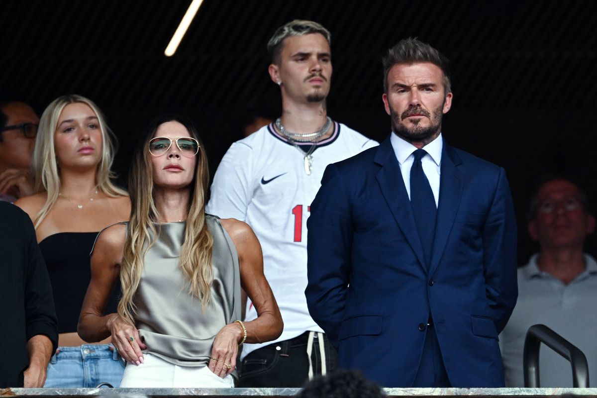 David Beckham and his wife stood in the stands during the England-Norway match