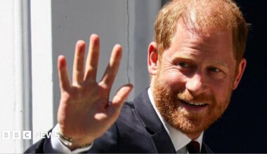 Close up photo of Prince Harry smiling and waving