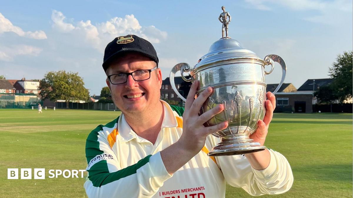 Brian Devine holding a trophy from the Bradford Cricket League in 2023
