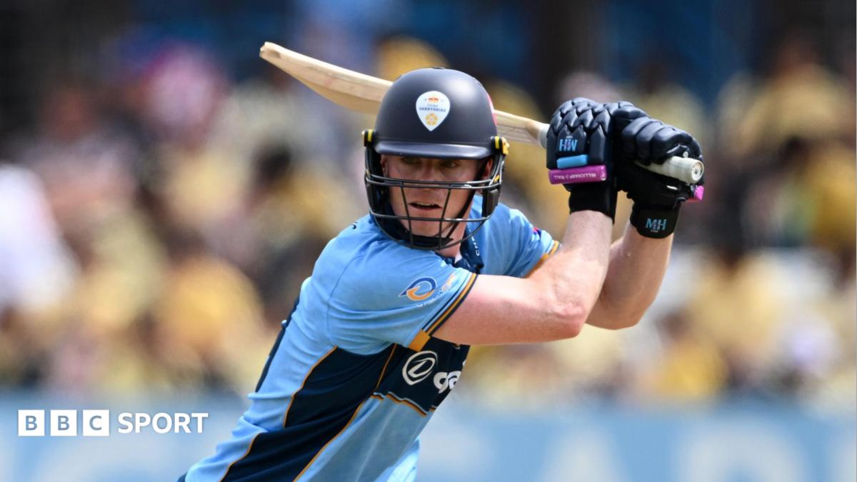 Right-handed Brooke Guest plays a shot through the covers in blue Derbyshire kit