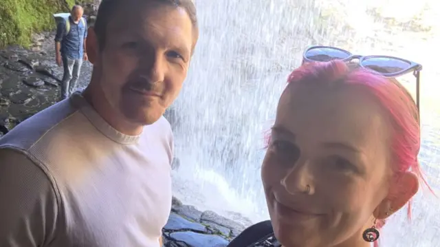 A selfie of Wayne and Paige from a waterfall