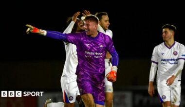 A photo of Mason Terry, in his purple goalkeeping kit for Braintree Town, celebrating a goal against Truro City in the National League Cup in February