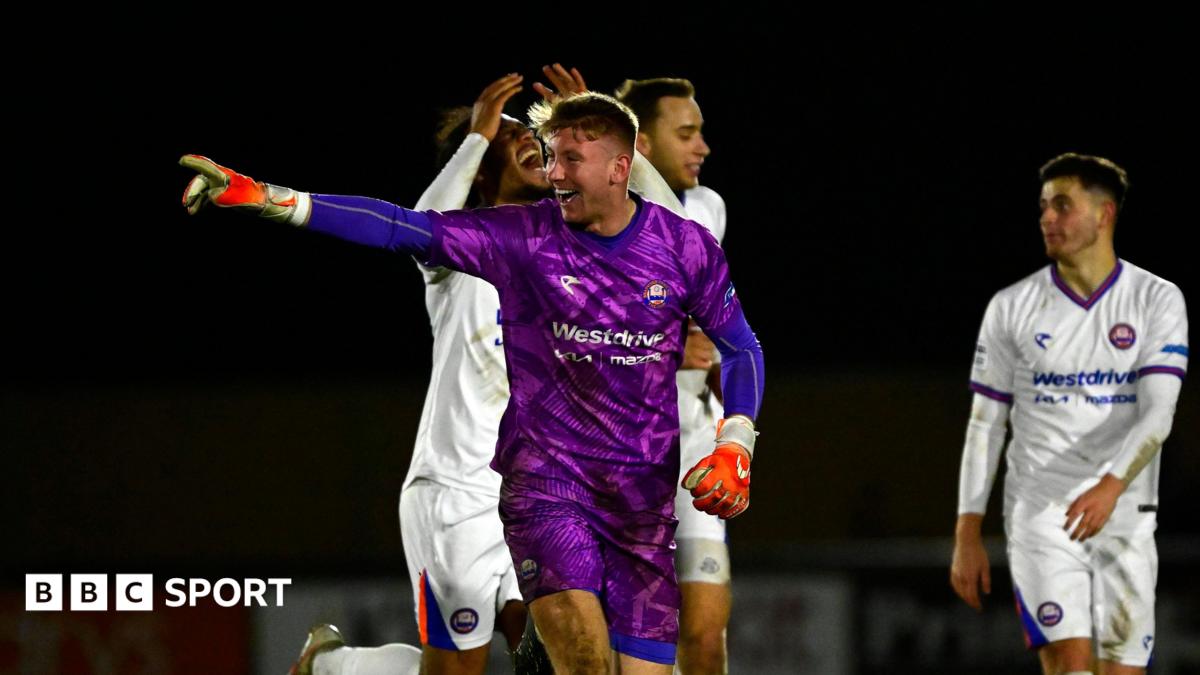 A photo of Mason Terry, in his purple goalkeeping kit for Braintree Town, celebrating a goal against Truro City in the National League Cup in February