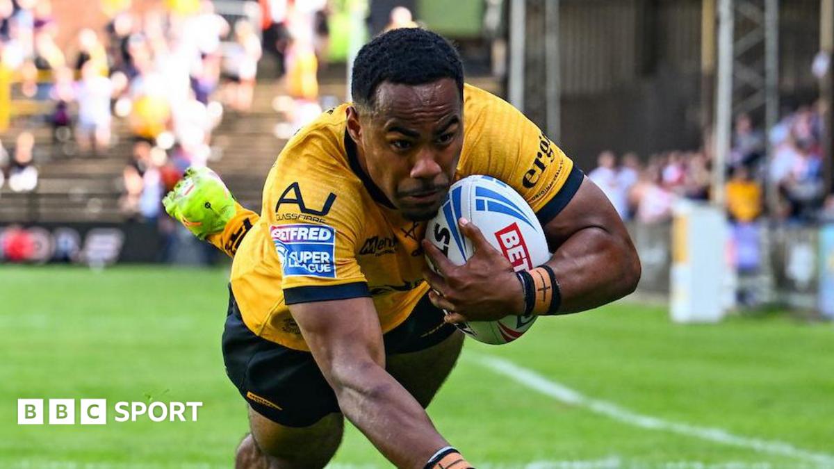 Castleford Tigers' Jason Qareqare diving for the line with the ball in his left hand.