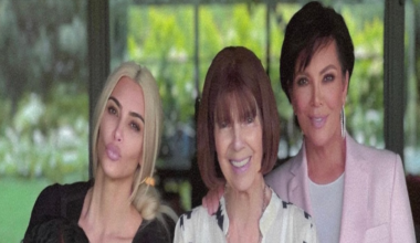 This photo shows Kim, her daughter, Mary Jo and Kris posing together smiling. They are standing by some bright pink flowers.